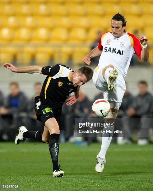 Angelo Costanzo of Adelaide competes for the ball with Shane Smetlz of the Phoenix during the round five A-League match between the Wellington...