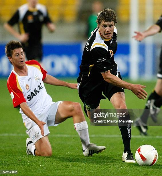 Tony Lochhead of the Phoenix is tackled by Nathan Burns of Adelaide during the round five A-League match between the Wellington Phoenix and Adelaide...