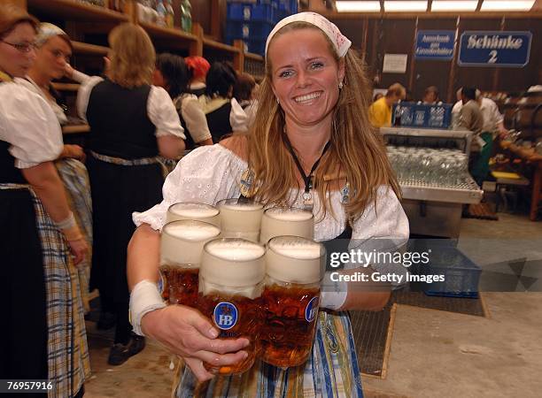 Babsi Stadlhuber, Oktoberfests most famous waitress, serves hugs of beer in the Hofbraeuhaus tent after the ceremonial opening of the Oktoberfest...