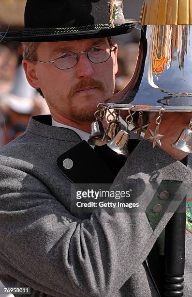 Bandmaster of a bavarian brass band carries a traditional flagpole during the ceremonial opening of the Oktoberfest beer festival on September 22,...