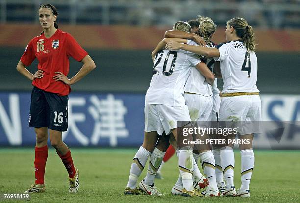 Jill Scott of England looks on as US team players celebrate a goal against England in their quarterfinal match of the FIFA Women's World Cup football...