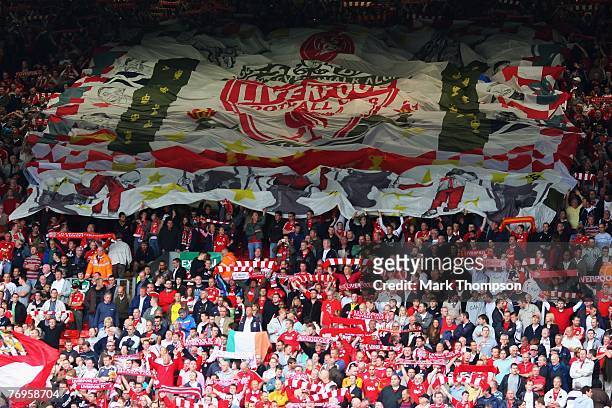 Liverpool fans unfurl a flag at the Kop end of the stadium prior to the Barclays Premier League match between Liverpool and Birmingham City at...