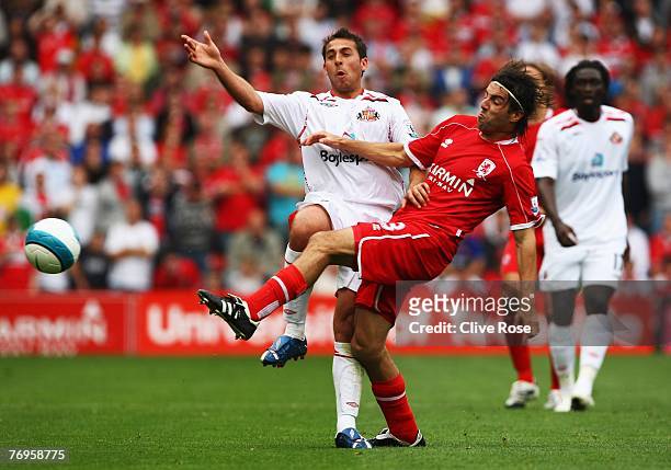 Michael Chopra of Sunderland is challenged by Julio Arca of Middlesbrough during the Barclays Premier League match between Middlesbrough and...