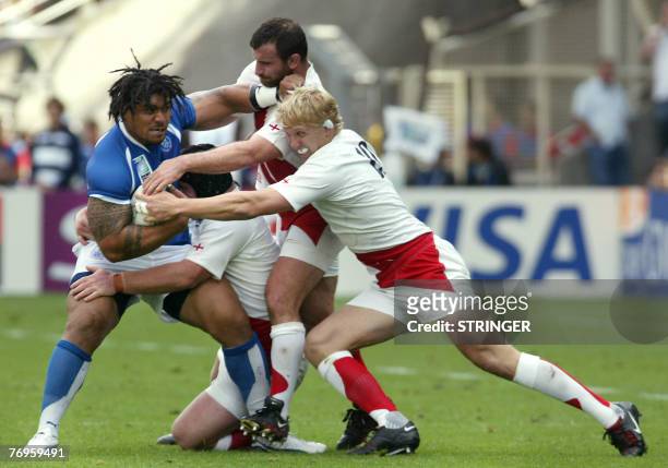 Samoa's prop Alfie Vaeluaga vies with England's lock Ben Kay, hooker George Chuter and flanker Lewis Moody during the rugby union World Cup group A...