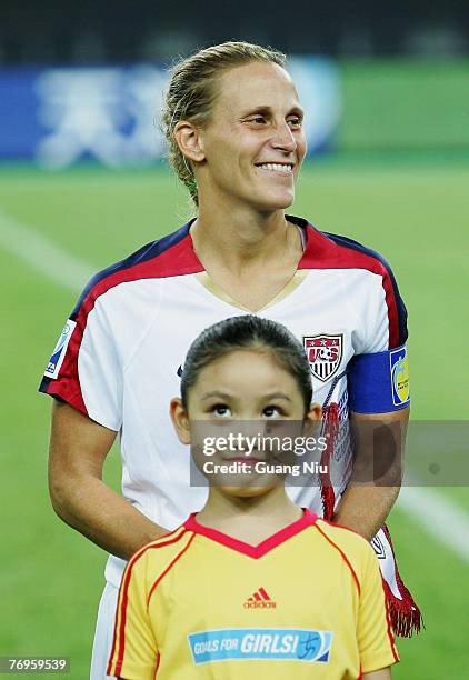 Kristine Lilly of the USA stands behind a Chinese girl on the pitch before the Women's World Cup 2007 quarter final match between the USA and England...