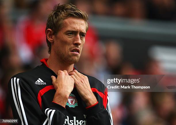 Substitute Peter Crouch of Liverpool looks on from the touchline during the Barclays Premier League match between Liverpool and Birmingham City at...