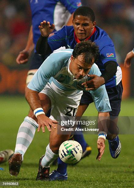 Nicolas Fernandez Miranda of Argentina loses his grip on the ball as he is tackled by Eugene Jantjies of Namibia during Match Twenty Six of the Rugby...