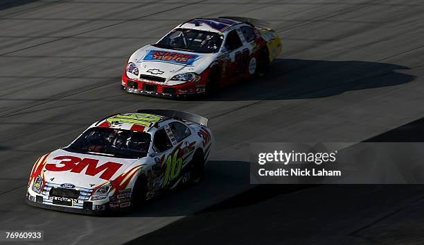 Greg Biffle, driver of the 3M Ford, drives ahead of Robert Richardson Jr., driver of the Kibbles'n Bits Chevrolet, during the NASCAR Busch Series...