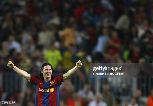 Barcelona's Argentinian Leo Messi celebrates the first goal against Sevilla during their Spanish League football match at Camp Nou stadium in...