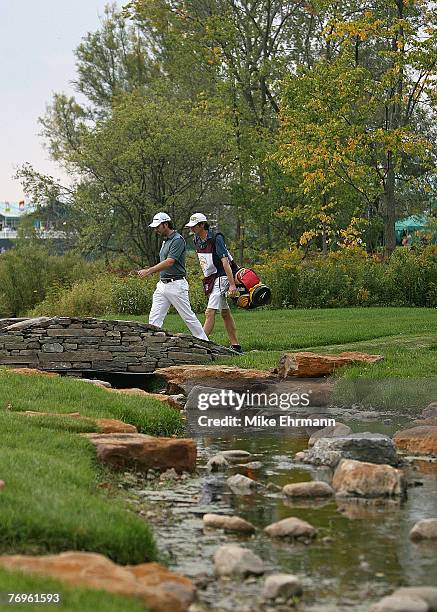 Mathew Goggin walks over the bridge on the 11th hole during the third round of the Turning Stone Resort Championship at Atunyote Golf Club, September...