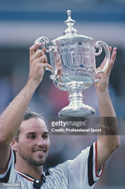 Australian tennis player Patrick Rafter lifts the US Open trophy after defeating fellow Australian Mark Philippoussis 6-3, 3-6, 6-2, 6-0 to win the...
