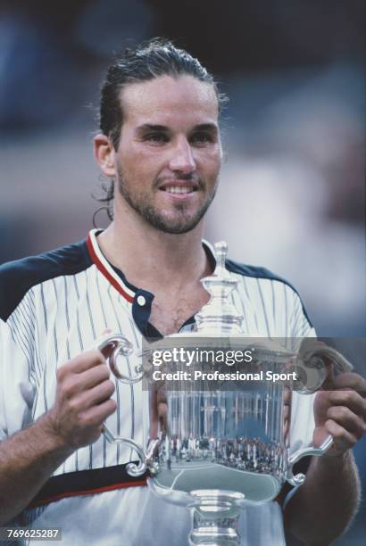 Australian tennis player Patrick Rafter holds the US Open trophy after defeating fellow Australian Mark Philippoussis 6-3, 3-6, 6-2, 6-0 to win the...