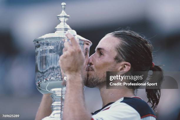 Australian tennis player Patrick Rafter kisses the US Open trophy after defeating fellow Australian Mark Philippoussis 6-3, 3-6, 6-2, 6-0 to win the...