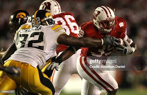 Hill of the Wisconsin Badgers runs past the reach of Ken Iwebema of the Iowa Hawkeyes at Camp Randall Stadium September 22, 2007 in Madison,...