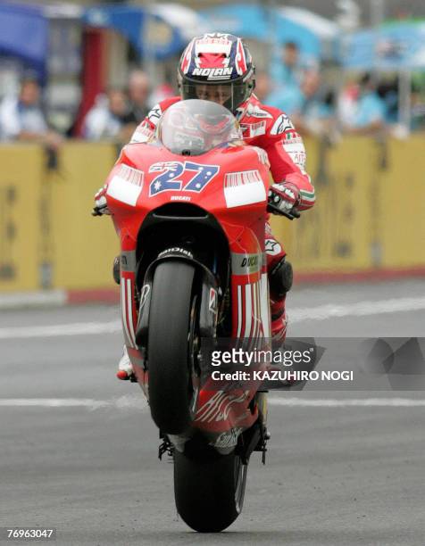 Casey Stoner of Australia, Ducati Marlboro team, powers his motrorbike at the Japanese Grand Prix in Twin Ring Motegi, 23 September 2007. Stoner won...