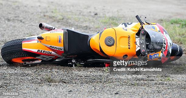 Dani Pedrosa's Repsol Honda bike lies in the gravel after taking a tumble during Round 15 of the 2007 MotoGP World Championship, the Japanese Grand...
