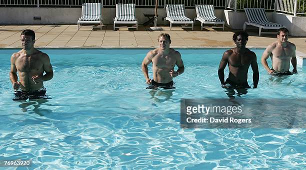 Joe Worsley, Josh Lewsey, Paul Sackey and Mark Cueto of England relax in the swimming pool during an England recovery session at the Hotel du Golf...