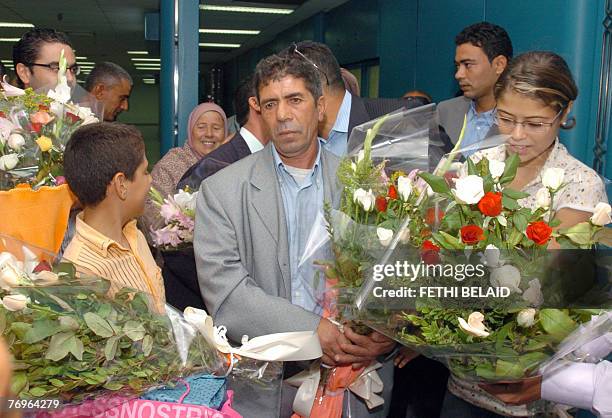 Tunisian fisherman boat captain Abdelkarim Bayouth surrounded by his familly upon his arrival 23 September 2007 at the Tunis-Carthage airport after...