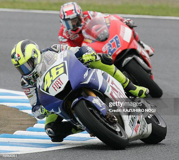 Five-time world champion Valentino Rossi of Italy , Fiat Yamaha Team, leads Casey Stoner of Australia, Ducati Marlboro Team, during the MotoGP race...