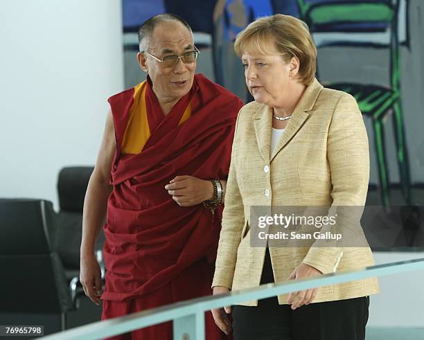German Chancellor Angela Merkel walks with the Dalai Lama after private talks at the Chancellery September 23, 2007 in Berlin, Germany. China has...