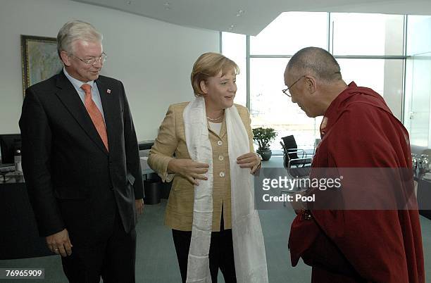 German Chancellor Angela Merkel receives a white scarf from the Dalai Lama at the Chancellery September 23, 2007 in Berlin, Germany. China has...