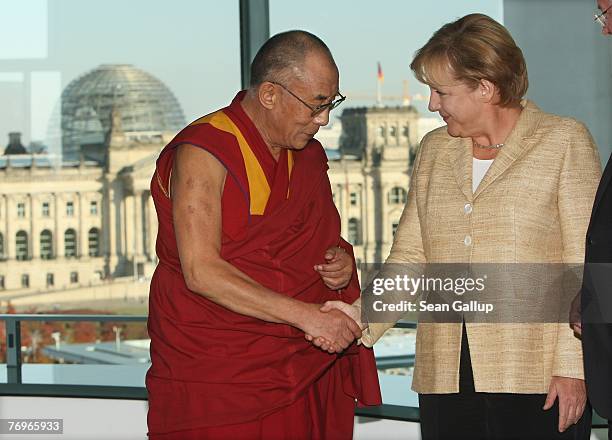 German Chancellor Angela Merkel shakes hands with the Dalai Lama after private talks at the Chancellery September 23, 2007 in Berlin, Germany. China...