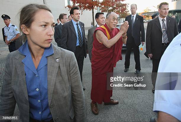 The Dalai Lama greets well-wishers outside the Chancellery after a private meeting with German Chancellor Angela Merkel September 23, 2007 in Berlin,...