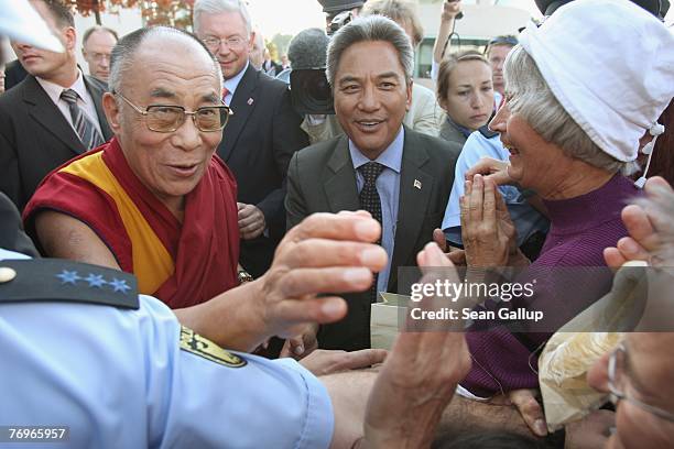 The Dalai Lama greets well-wishers outside the Chancellery after a private meeting with German Chancellor Angela Merkel September 23, 2007 in Berlin,...