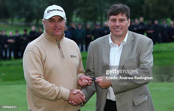 Stephen Dodd of Wales receives the keys to a Jaguar car for his nearest-the-pin prize after the final round of the Quinn Direct British Masters on...