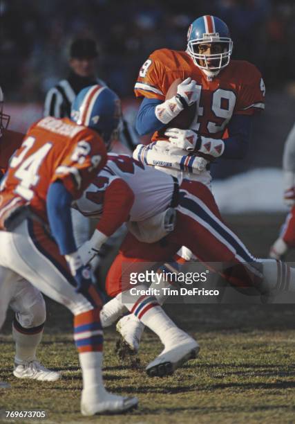 Dennis Smith, Strong Safety for the Denver Broncos runs the ball during the American Football Conference West game against the New England Patriots...