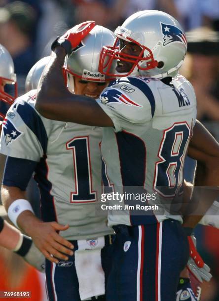 Randy Moss and Tom Brady of the New England Patriots celebrate a touchdown by Jabar Gaffney during a game against the Buffalo Bills at Gillette...