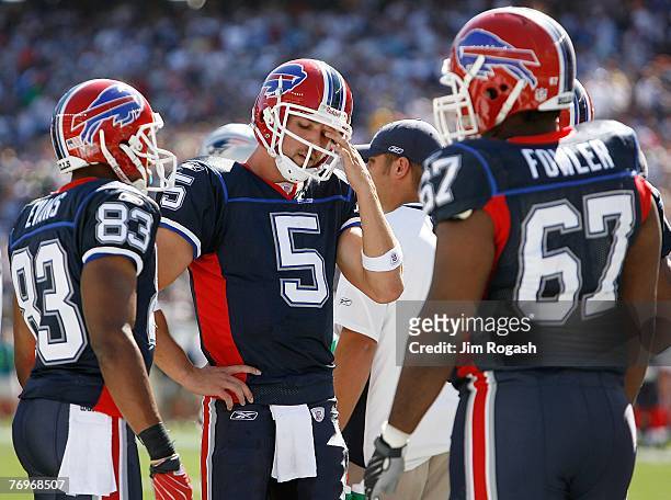 Quarterback Trent Edwards of the Buffalo Bills rubs his eye as teammates Lee Evan and Melvin Fowler look on during a game against the Buffalo Bills...