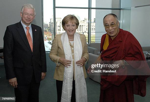 In this photo provided by Bundesregierung, Hessen's State Premier Roland Koch and German Chancellor Angela Merkel meet with the Dalai Lama in the...