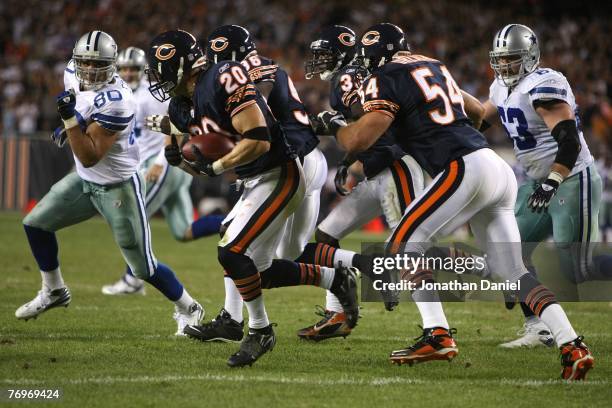 Adam Archuleta of the Chicago Bears advances the ball after teammate Israel Idonije blocked a field goal attempt against the Dallas Cowboys at...