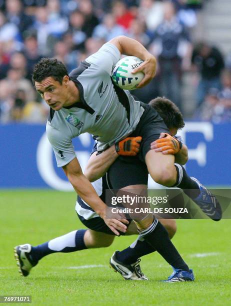 New Zealand's fly-half Daniel Carter is tackled by Scotland's fullback Hugo Southwell during the rugby union World cup match Scotland vs. New...