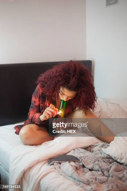 young woman smoking a bong - pipe smoking women stock pictures, royalty-free photos & images