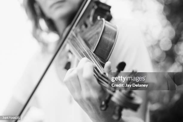 midsection of woman playing violin - tuning peg stock pictures, royalty-free photos & images