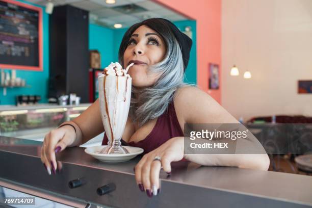 young woman in a diner. - milchshake stock-fotos und bilder