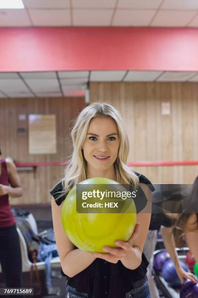a young woman with a yellow bowling ball. - bowlingkugel stock-fotos und bilder