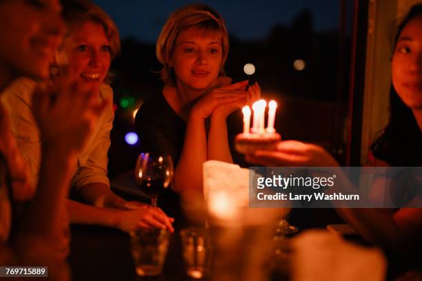 female friends celebrating birthday at home during night - white candle stock pictures, royalty-free photos & images