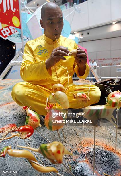 Stage performer Ma Chi Wang blows candy into various intricate animal shapes during a promotion for the upcoming moon festival in Hong Kong, 20...