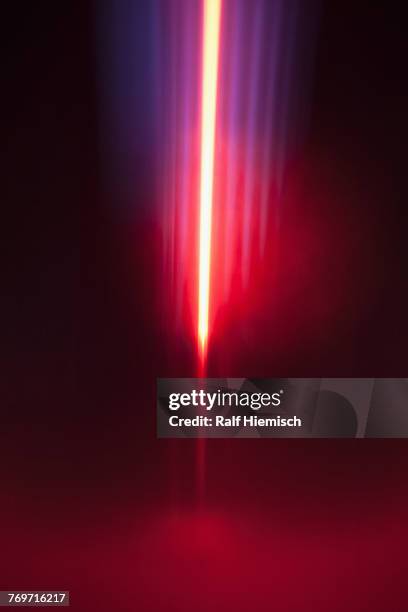 close-up of abstract red and blue light trails against black background - light trail imagens e fotografias de stock