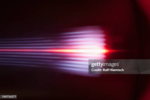 abstract light trails against black background - blendenfleck stock-fotos und bilder