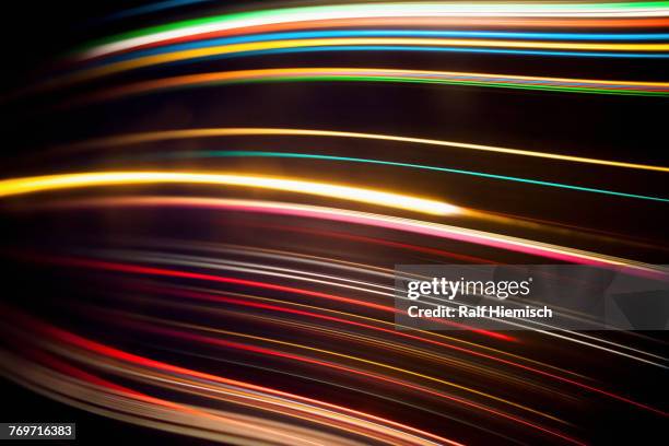 full frame abstract image of various light trails against black background - abstract shapes pink orange and black stock pictures, royalty-free photos & images