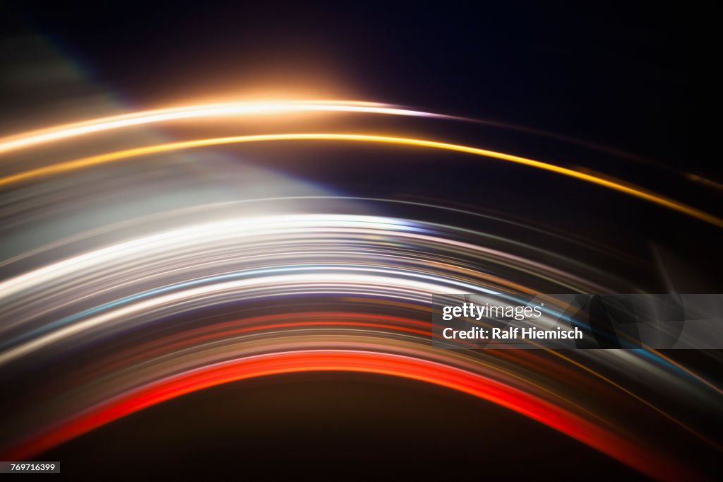 Various abstract light trails against black background