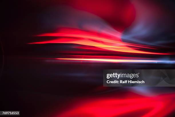 full frame abstract image of vibrant red light trails - equipamento de iluminação imagens e fotografias de stock