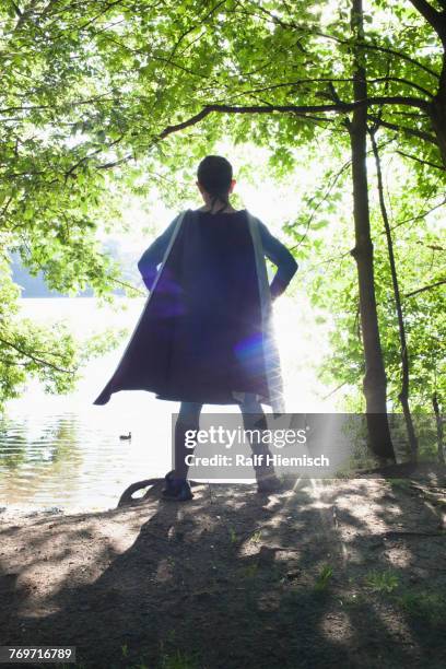 rear view of superhero standing at riverbank on sunny day - flowing cape 個照片及圖片檔