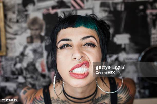 a portrait of a young woman making a face. - punk stockfoto's en -beelden