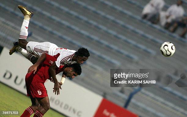 United Arab Emirate's Faisal Khalil dives onto the back of Lebanon's Faisal Antar to head the ball during an international football friendly in...