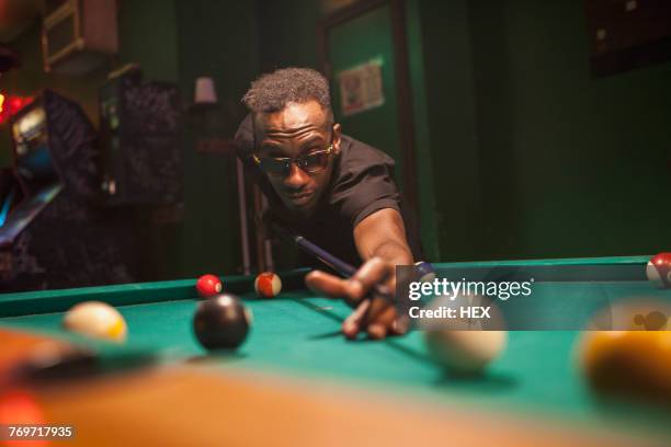 a young man playing pool. - pool cue sport stock pictures, royalty-free photos & images